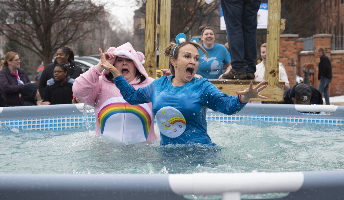 Plungers react to hitting the icy water at a Polar Plunge