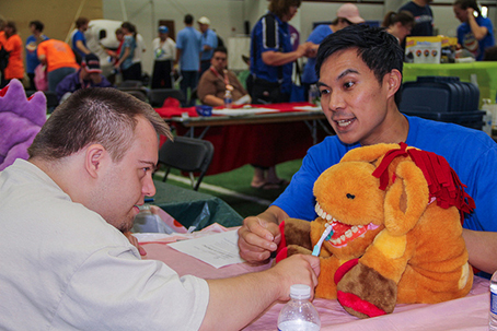 An athlete learns about dental cleanings