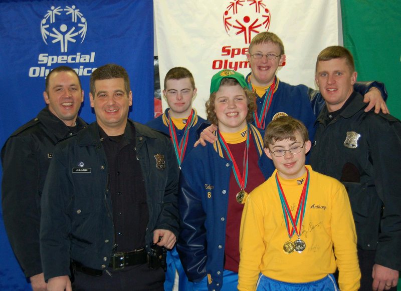 Athletes and LETR members post for a photo.
