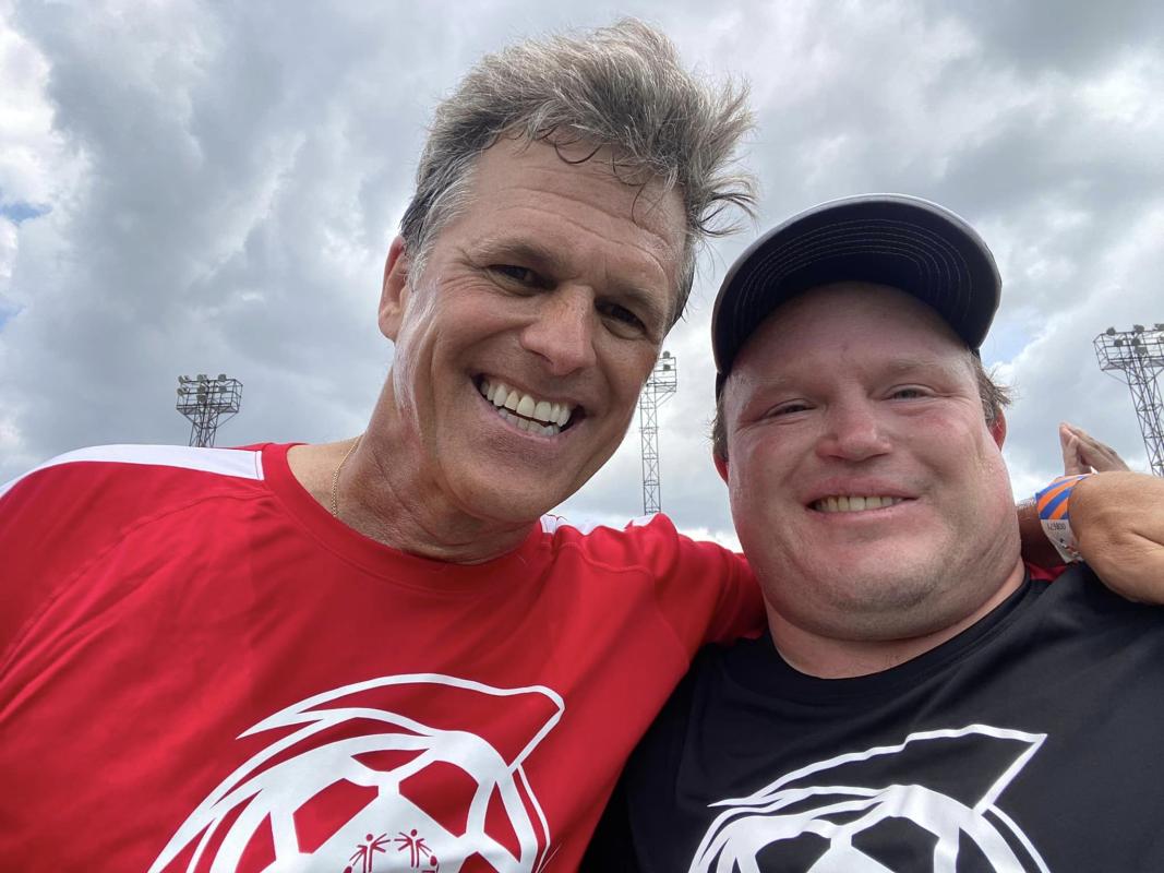 Ben Haack on the pitch with SO Chairman Tim Shriver at Unified Cup.