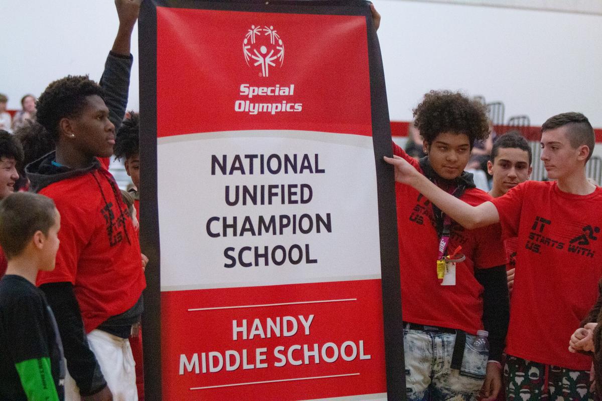 Students at Handy Middle School raise the school's National Banner