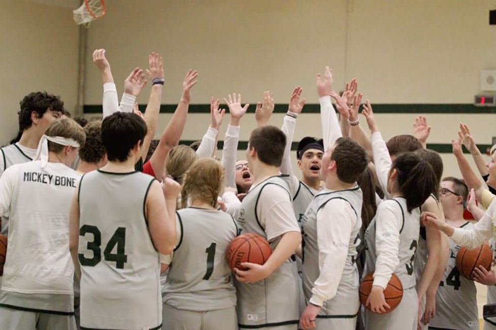 Howell High School Students huddle up during a basketball game