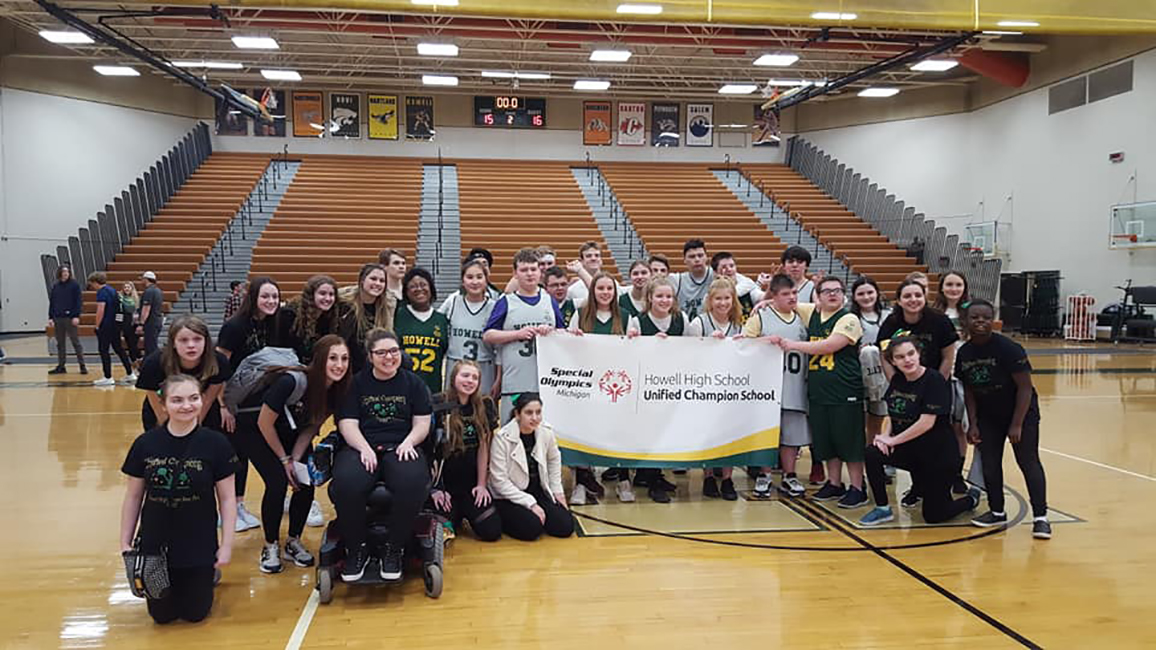 Students at Howell High School pose with a Unified Champion Schools banner.