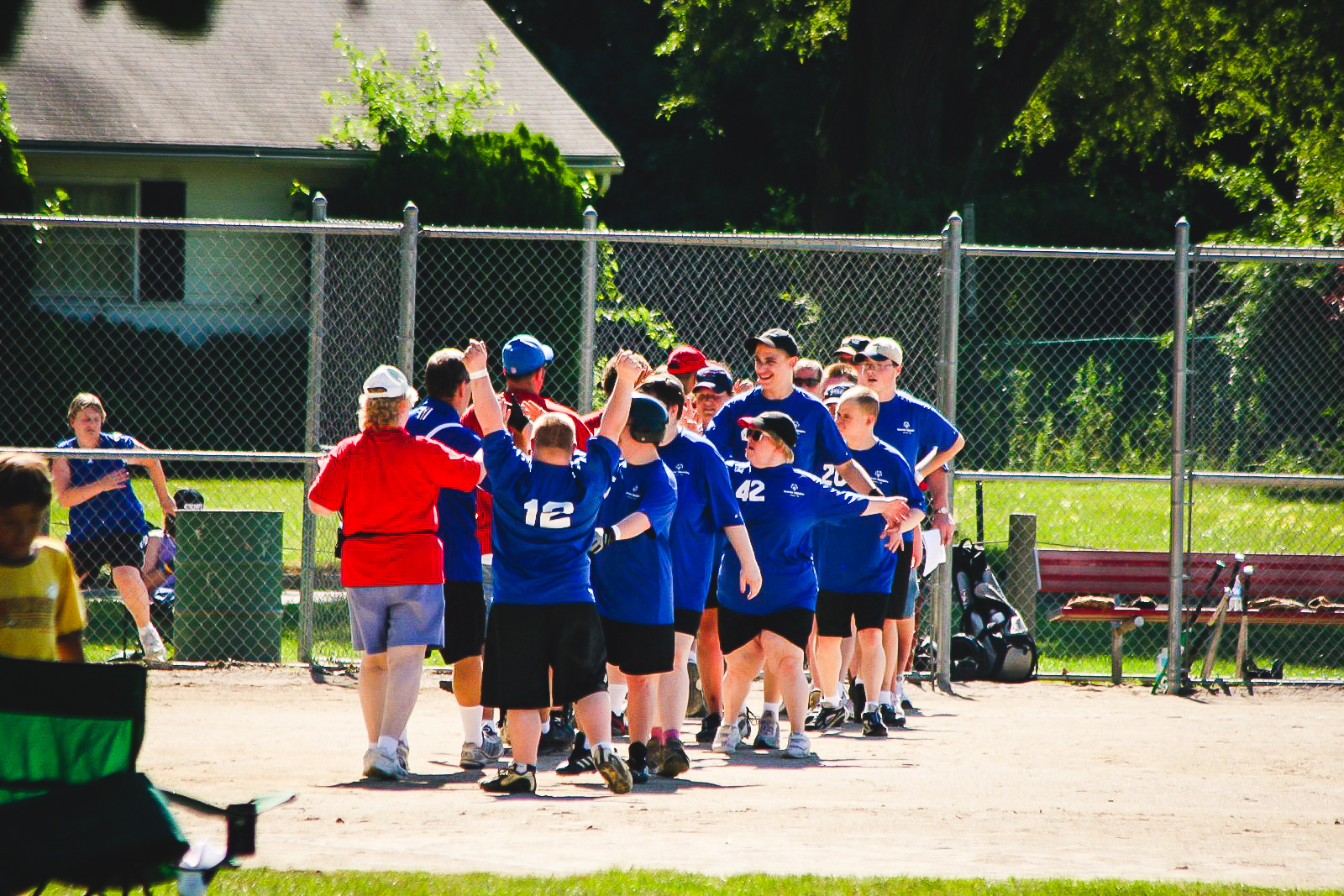 team celebrating after softball game