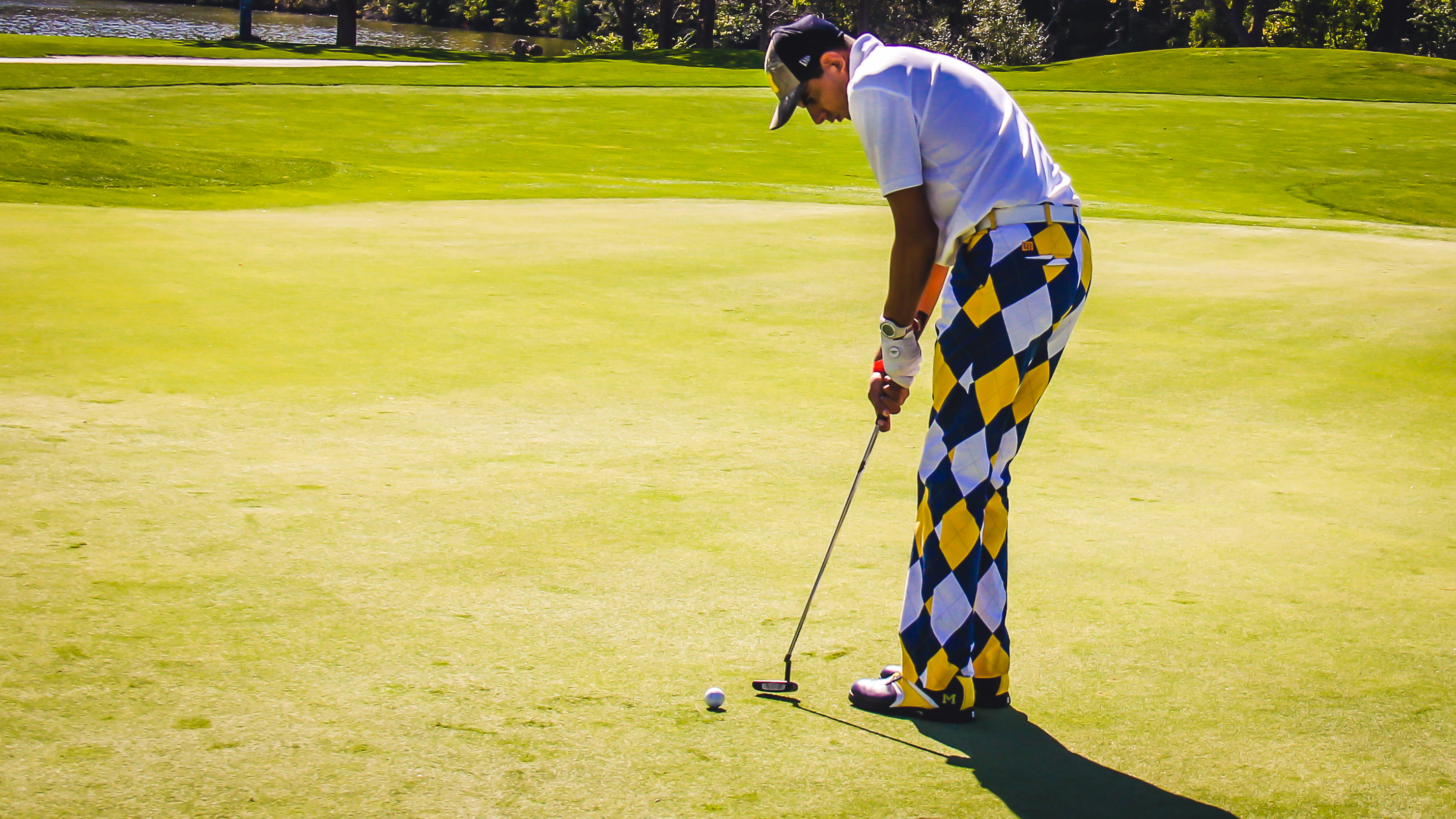 athlete golfing on green