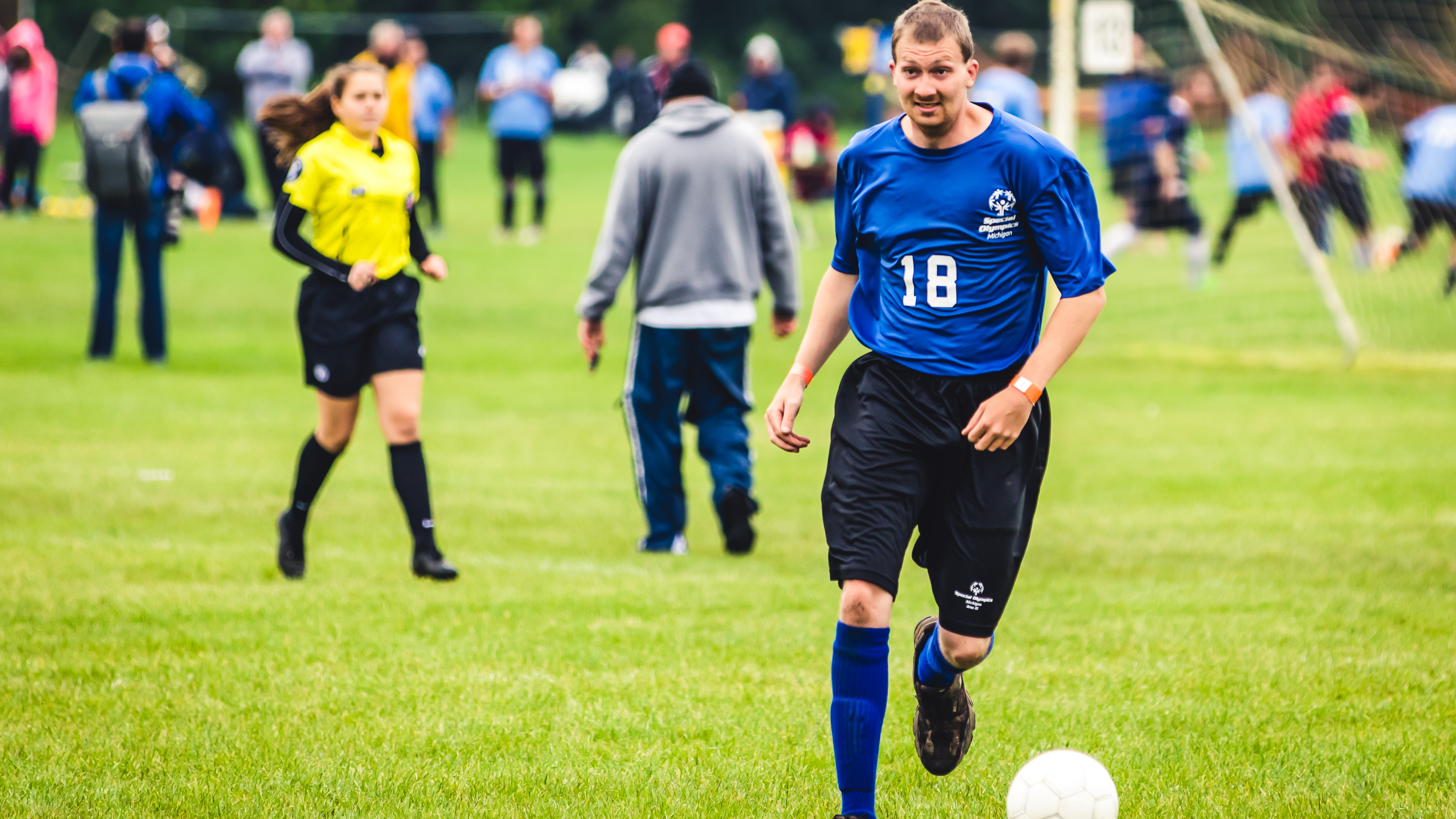 athletes playing soccer on a field