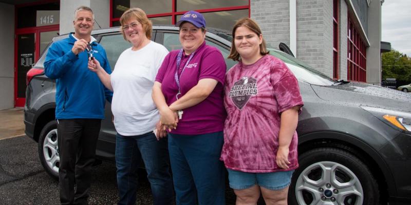 Raffle winner Teresa Carlson receives the keys to her brand new Ford Escape.