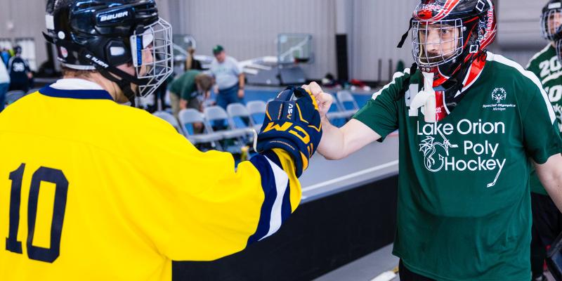 Poly Hockey athletes fist bump