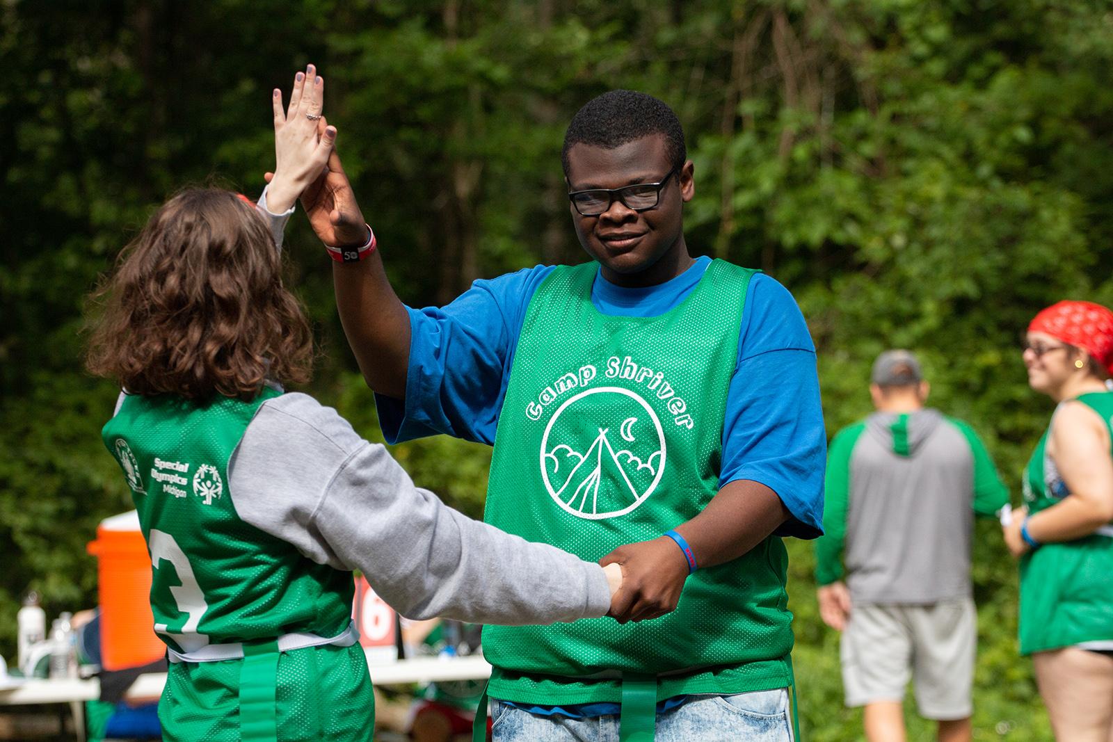 Camp Shriver campers give each other high fives