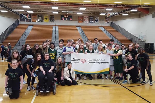 Students at Howell High School pose with a Unified Champion Schools banner.